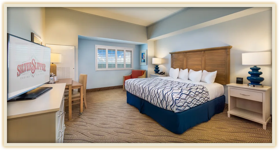 Silver Slipper king room with seating area and coastal furnishings