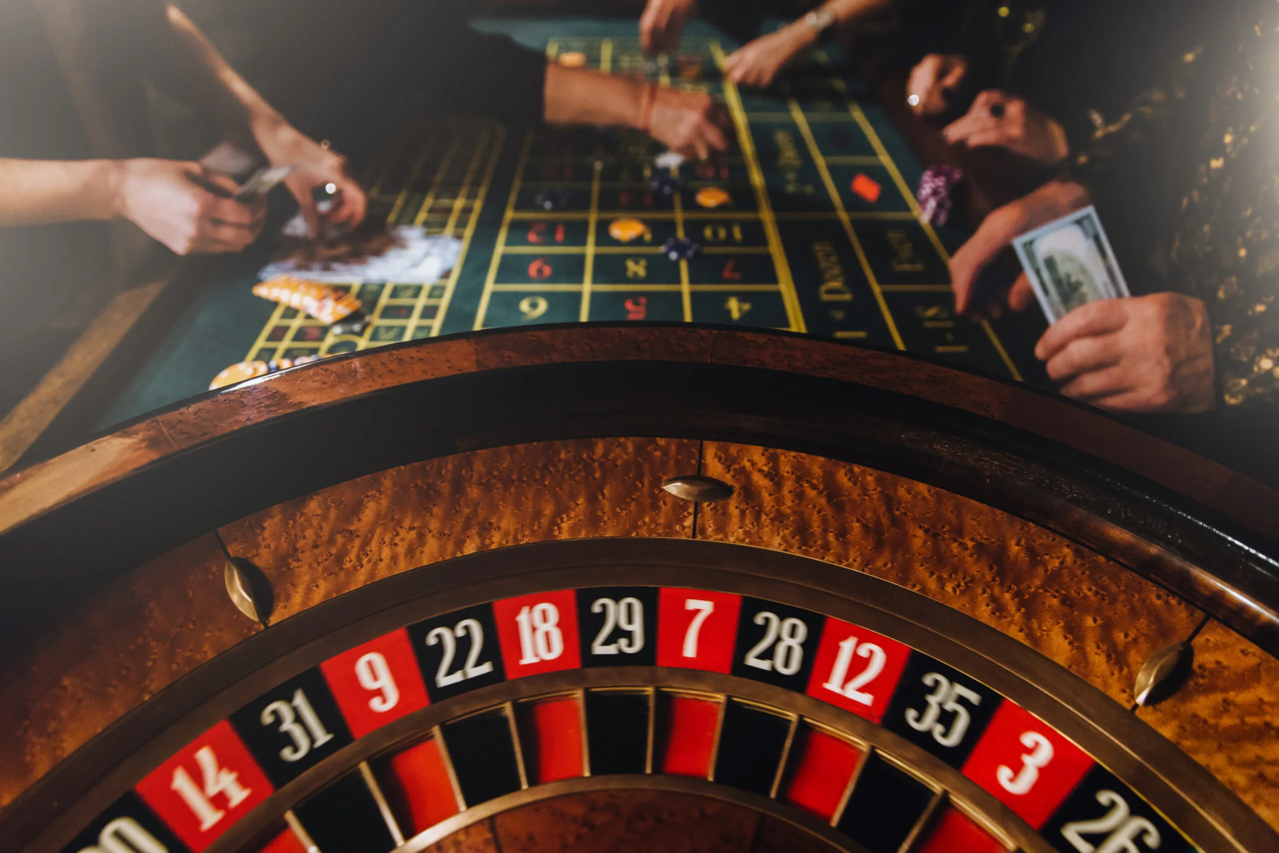 Guests gathered around a casino roulette table